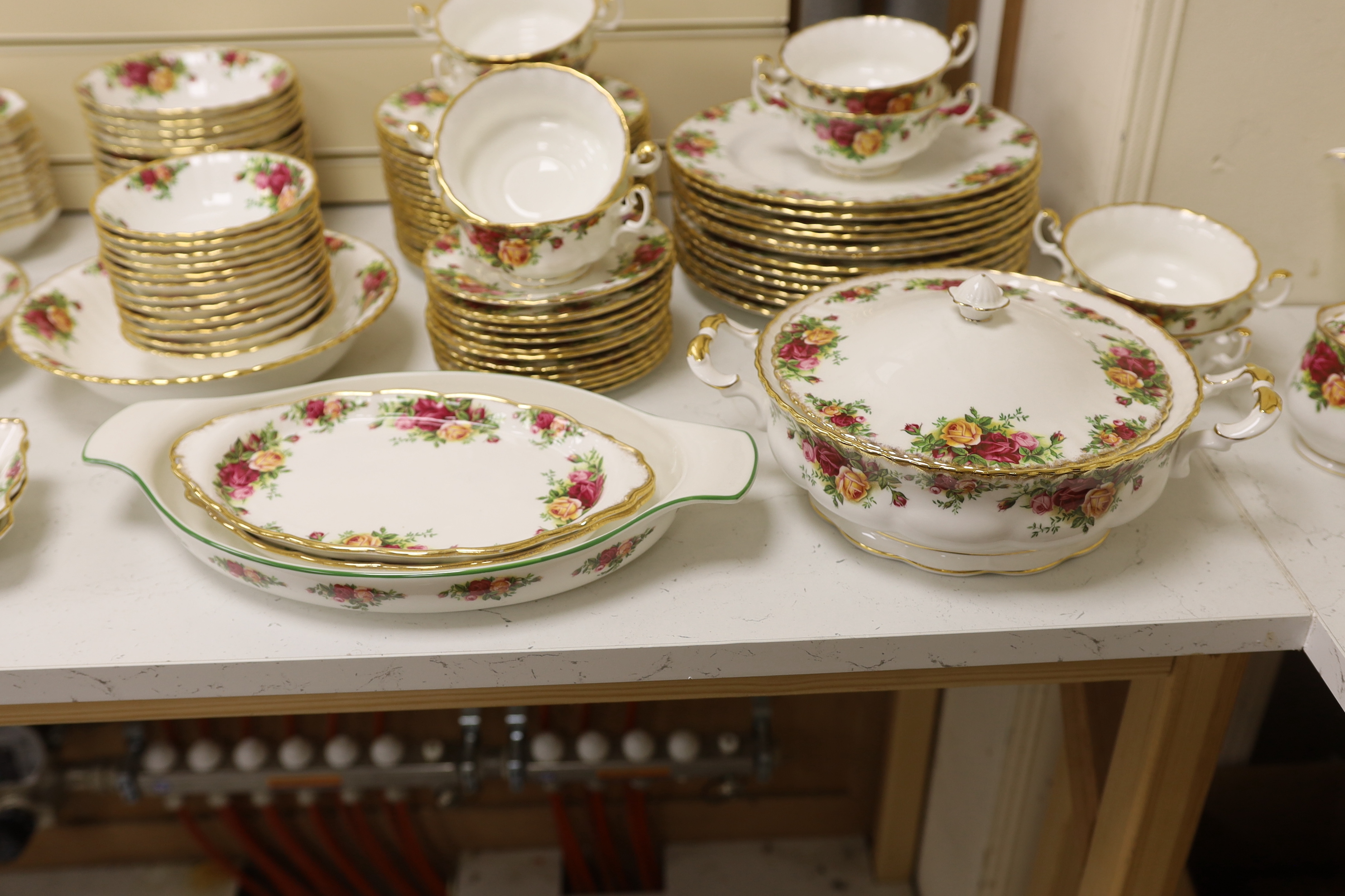 Royal Albert Old Country Roses, a large bone china service for twelve-place setting, and related accessories telephone, wall clock, table mats, napkins and cutlery.